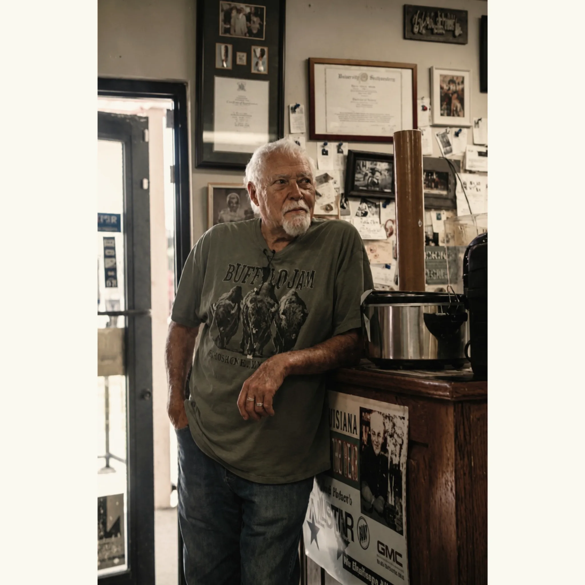 Earl Booth Jr. inside Booth’s Grocery, surrounded by family photographs